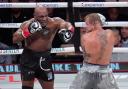 Mike Tyson, left, fights Jake Paul during their heavyweight boxing match in Arlington, Texas (Julio Cortez/AP)