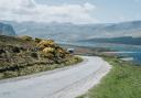 A campervan approaches on the NC500 route in Scotland