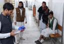 An injured victim awaits hospital treatment (Dilawar Hussain/AP)