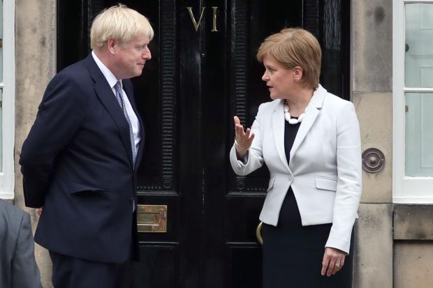 Scotland's First Minister Nicola Sturgeon welcoming Prime Minister Boris Johnson outside Bute House in Edinburgh
