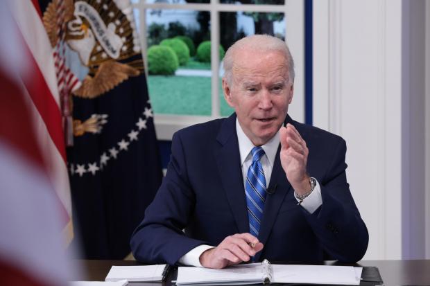 The National: WASHINGTON, DC - DECEMBER 27: U.S. President Joe Biden speaks during a video call with the White House Covid-19 Response team and the National Governors Association in the South Court Auditorium at the Eisenhower Executive Office Building on December 27,
