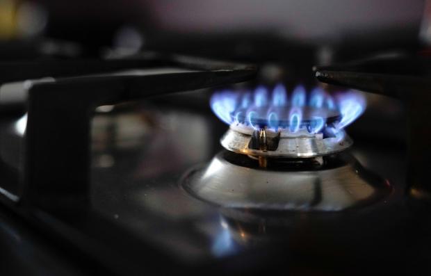 The National: General view of a gas hob burning on a stove in a kitchen in Basingstoke, Hampshire. Ofgem is expected to announce that the energy price cap is to rise by 50 percent because of soaring wholesale gas prices, meaning the average bill could hit