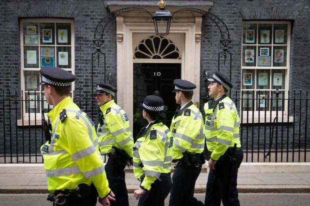 A group of police officers walk through Downing Street