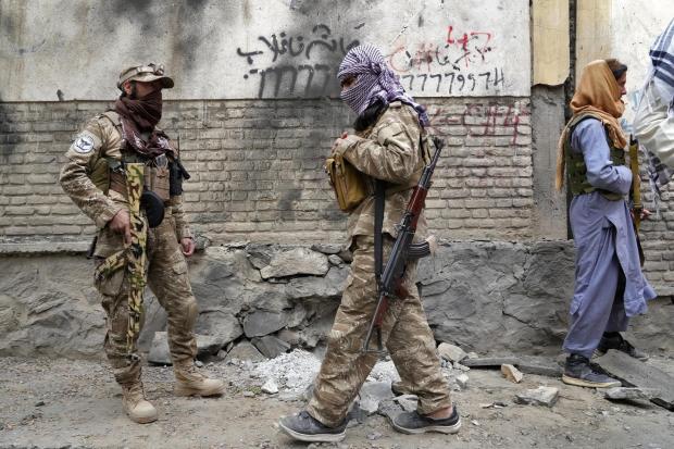 The National: Taliban fighters stand guard at the site of an explosion in front of a school, in Kabul, Afghanistan, Tuesday, April 19, 2022. An Afghan police spokesman says explosions targeting educational institutions in Kabul have killed at least six civilians and
