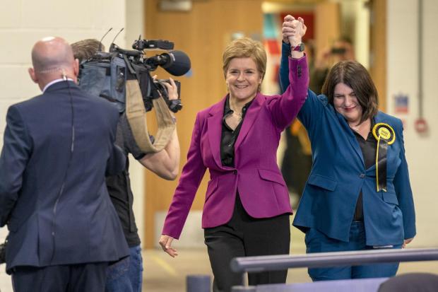 First Minister Nicola Sturgeon arrives to the vote count in Glasgow with Susan Aitken (right)