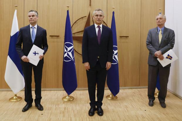 From left: Finland's Ambassador to Nato Klaus Korhonen, Nato Secretary-General Jens Stoltenberg and Sweden's Ambassador to Nato Axel Wernhoff attended a ceremony to mark Sweden's and Finland's application for membership