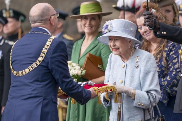 Queen Elizabeth inspects the keys presented by Lord Provost Robert Aldridge (left) during the Ceremony of the Keys on the forecourt of the Palace of Holyroodhouse in Edinburgh