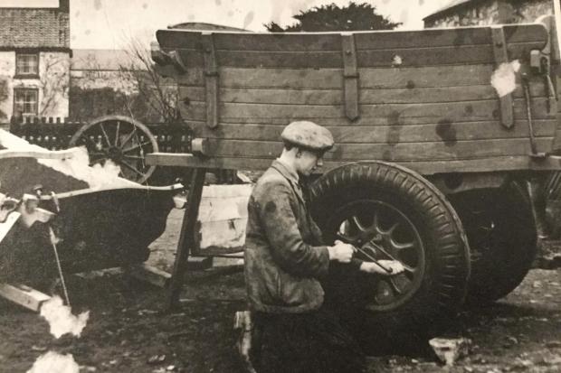 Wilf Hare repairs a cart with a revolutionary Dunlop pneumatic tyre at his father's business in Snape before the outbreak of the Second World War