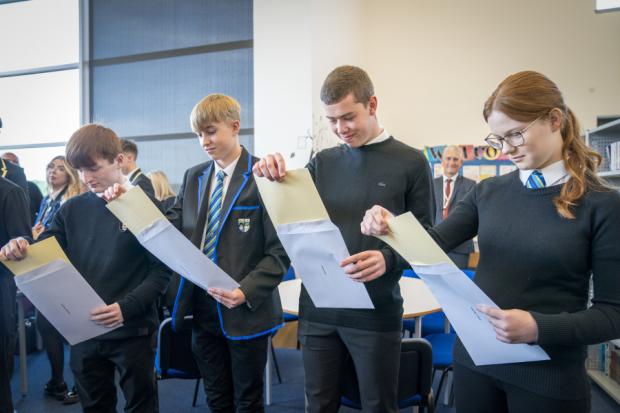 Students (from left) Michael Stewart, Aaron Boyack, John Poole and Claire McNab at Auchmuty High School in Glenrothes, Fife, open their exam results. Photo: PA