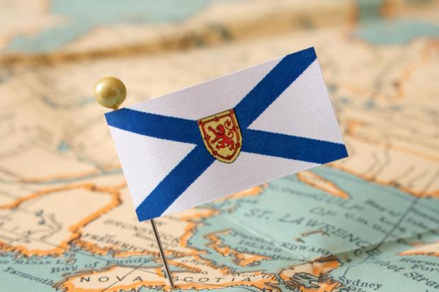 The flag of Nova Scotia pinned on a map of the Canadian province