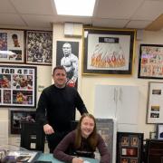 Cassidy Todd signing for St Andrew’s Sporting Club with owner Iain Wilson