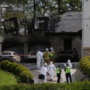 Investigators and firefighters pictured at the home of former Celtic chief executive Peter Lawwell in Thorntonhall near Glasgow