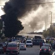 Black smoke rises from the scene where a fuel tanker exploded, in Tleil village, north Lebanon, Sunday, Aug. 15, 2021. A fuel tanker exploded early Sunday in northern Lebanon, killing and wounded several people, the Lebanese Red Cross said. The explosion