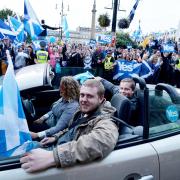 Yes campaigners drive through George Square at a rally during the final day of campaigning for the Scottish referendum