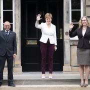 Nicola Sturgeon, centre, agreed on a deal with Scottish Greens co-leaders Patrick Harvie and Lorna Slater
