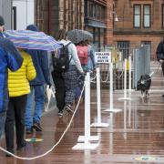 Voters in a physically-distanced queue outside a polling station in Glasgow on May 6. Pic: Colin Mearns