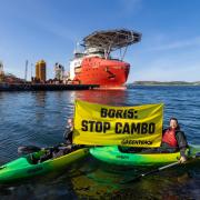 Greenpeace Norway activists in kayaks confront Siem Day loading drilling infrastructure for the Cambo oil field on behalf of Siccar Point Energy and Shell Oil, at Randaberg Industries, outside Stavanger, Norway.