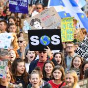 Climate protestors marching in Edinburgh. The Paid 2 Pollute campaign supported the legal challenge by Kairin Van Sweeden, Mikaela Loach and Jeremy Cox