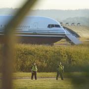 Police officers near a Boeing 767 aircraft at MoD Boscombe Down which is believed to be the plane set to take asylum seekers from the UK to Rwanda