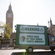 A mobile billboard van, commissioned by human rights organisation Liberty, outside the Houses of Parliament