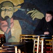 A young Kevin Bridges standing in front of the iconic mural