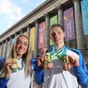 Scotland's Duncan Scott (right) and Eilish McColgan posing with their Commonwealth Games medals