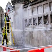 Workers clean white paint from the Palace of Westminster. Picture: Victoria Jones