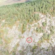 Abseilers (circled) captured by drone clearing the shrub on Migdale Rock, Sutherland