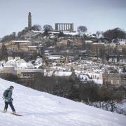 A person snowboards in Edinburgh's Holyrood Park in February 2021. The city recorded snowfall on December 25, making 2022 an official white Christmas