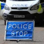 Stock image of a police sign and van