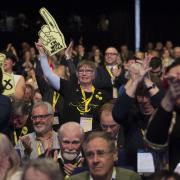 Delegates cheer an announcement during an SNP conference