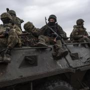 Ukrainian servicemen ride atop an APC towards frontline positions near Vuhledar, Ukraine.