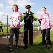 Protesters are removed by police during day three of the Randox Grand National Festival at Aintree Racecourse, Liverpool.