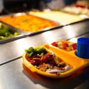 Free school meals will be brought in for all pupils in Scotland's primary schools, the deputy First Minister has insisted