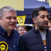 First Minister of Scotland Humza Yousaf with local SNP council candidate Joe Budd (left) during a visit to Bellshill in North Lanarkshire