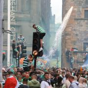 Celtic fans celebrate in Glasgow Cross after the team's Premiership victory