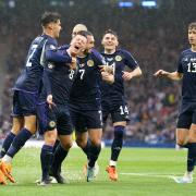 Callum McGregor (second left) had Scots cracking a smile … but not all is well