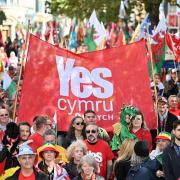 Protestors walk through Cardiff during a march in support of Welsh Independence in 2022