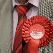 Stock image of a Labour candidate wearing a red rosette