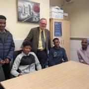 Day with his constituent Mr Omar, right, and his three sons who were stranded in Sudan