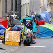 Homeless people consume illegal drugs in an encampment along Willow Street