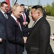 Russian President Vladimir Putin, left, and North Korea's leader Kim Jong Un shake hands