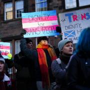 People take part in a demonstration for trans rights outside the UK Government Office at Queen Elizabeth House in Edinburgh