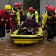 Members of the emergency services help local residents to safety in Brechin