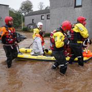 Members of the emergency services help local residents to safety in Brechin, Scotland, as Storm Babet batters the country.