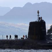 A Trident submarine makes its way out from Faslane Naval base in Faslane