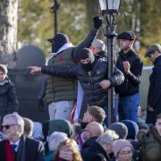 Far right groups and football hooligans watch members of the armed forces lay wreaths