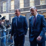 Britain's former Prime Minister, David Cameron (L), leaves 10 Downing Street with Sir Philip Barton, the Permanent Under-Secretary of the Foreign, Commonwealth and Development Office