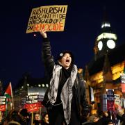 A protester holds a placard and chants slogans during a rally in support of Palestinians, outside of the Houses of Parliament in central London