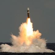 An unarmed Trident missile is fired from a submarine
